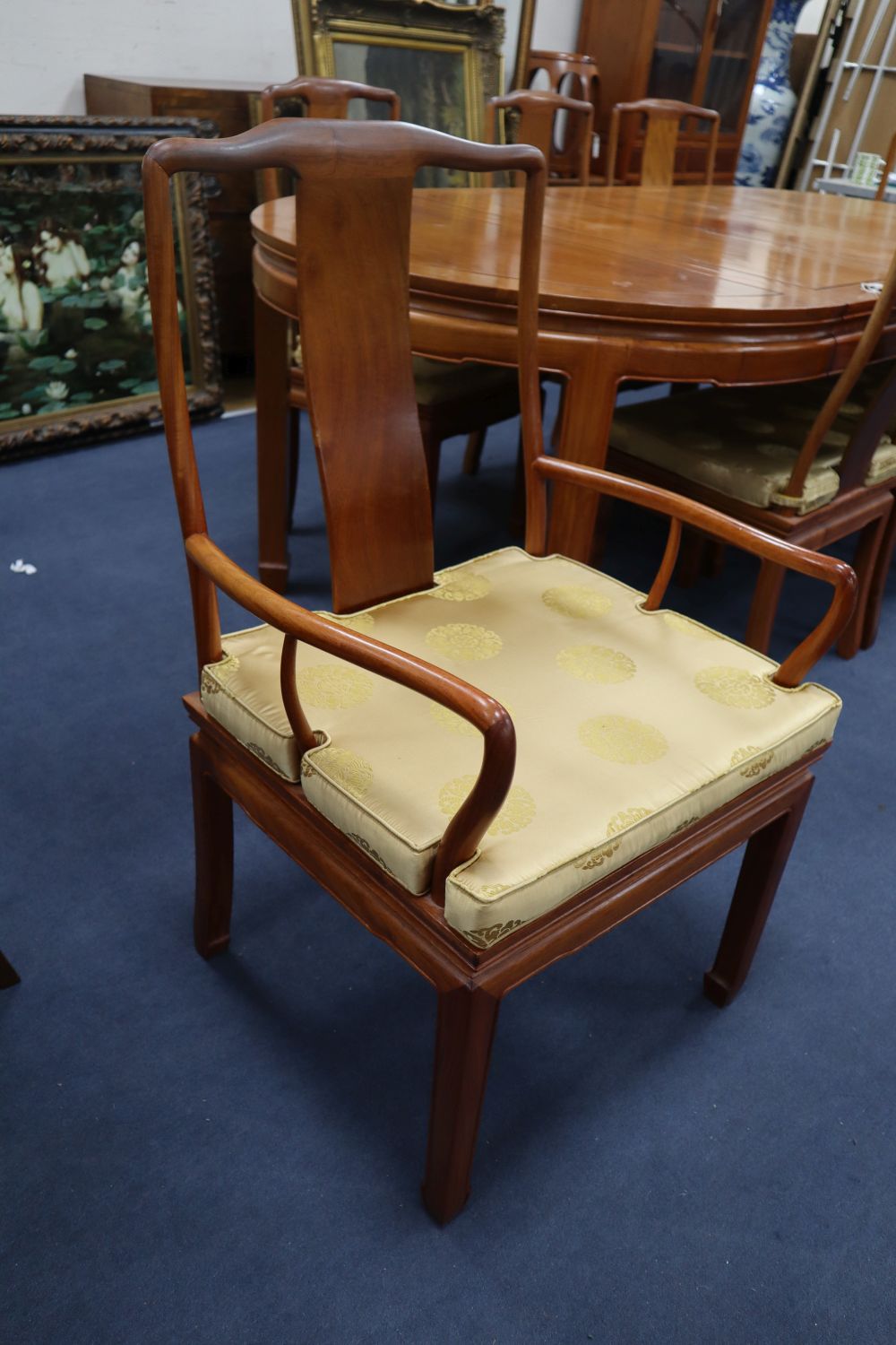 A Chinese hardwood dining table, 234cm extended (three spare leaves), width 112cm, height 76cm and eight chairs